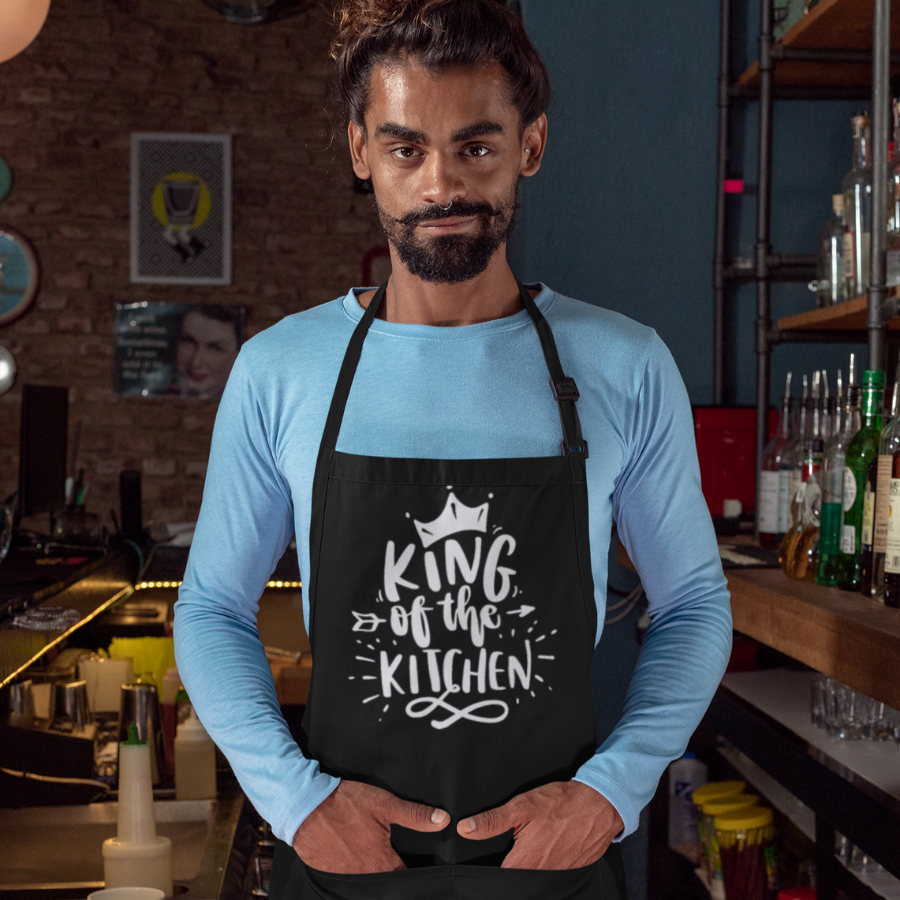 King of the Kitchen apron: A black apron with bold white text that reads 'King of the Kitchen,' perfect for adding a touch of humour to your cooking attire
